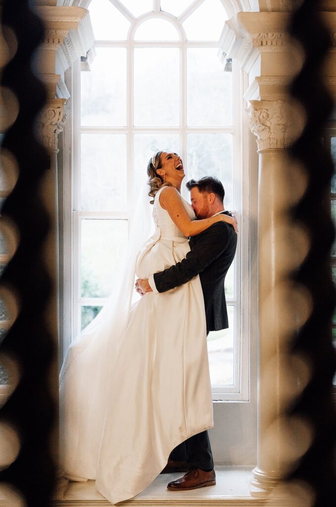 Groom lifts bride up
