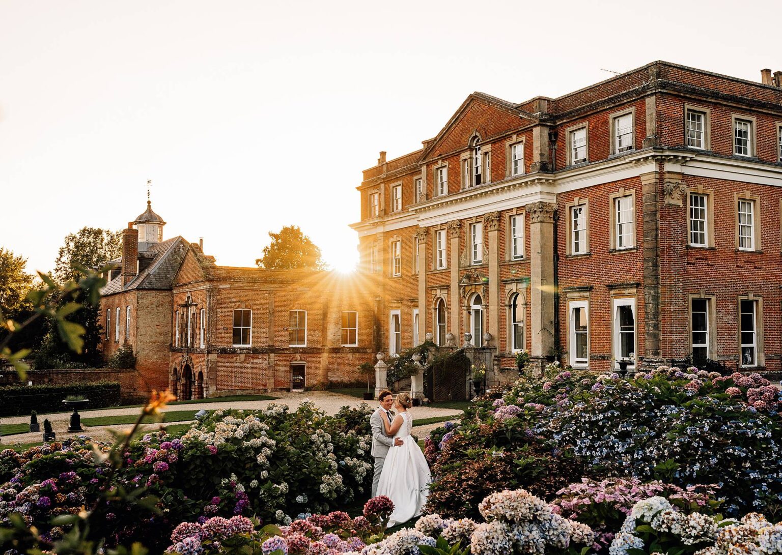 Bride and groom walk back towards Crowcombe Court
